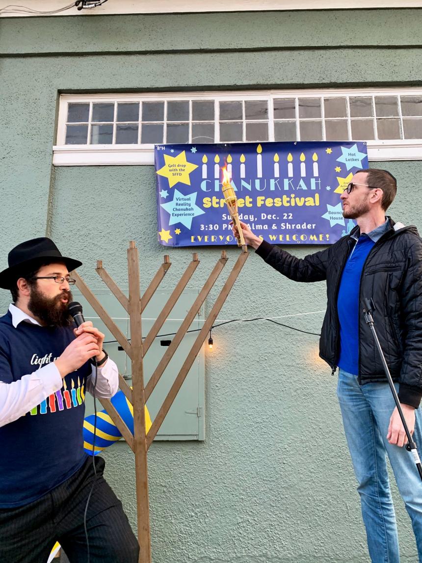 Senator Wiener lighting the menorah